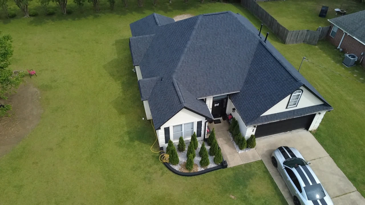 The same Oxford house after Cloud Nine's work: a new dark shingle roof from the same drone angle