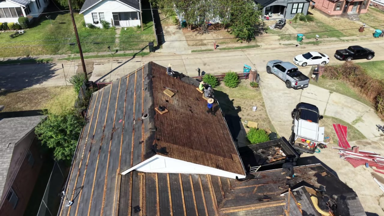 The Cloud Nine crew on a tear-off in Oxford, the old shingles off and the decking exposed